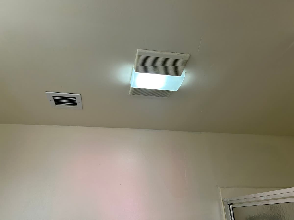Bathroom ceiling after — clean, smooth, repainted finish